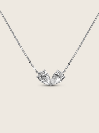 Adore necklace featuring two pear-cut cubic zirconia stones set side by side in white gold plated brass, symbolising love and unity on a fine chain, displayed on a neutral background