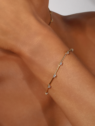 Gold plated Astra bracelet with cubic zirconia stars, styled on wrist