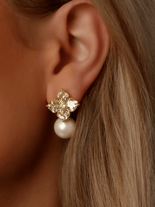 Crystal Hydrangea earring in lemon with 14k Gold plating, shown on model’s ear with faceted CZ petals and a pearl drop accent