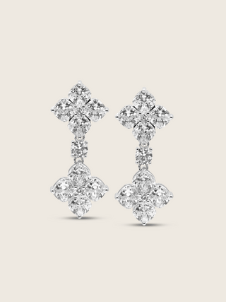 The Double Crystal Drop Hydrangea Earrings featuring two sparkling CZ stones linked by a delicate connecting stone, set in sterling silver with white gold plating, displayed on a clean white background.