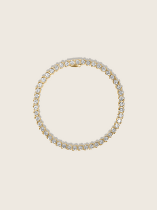 Estelle tennis bracelet 14k gold plated with cubic zirconia stones in S-link chain, circular flatlay