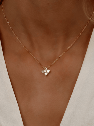 Close-up of model wearing Gold Mini Crystal Hydrangea Necklace in Lemon Drop, featuring a delicate yellow CZ flower pendant on the neckline