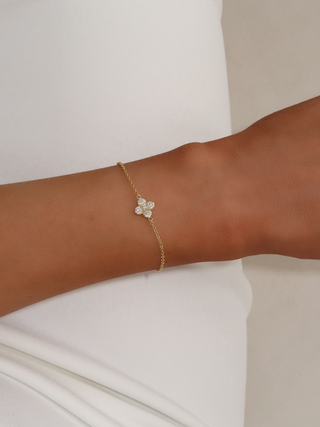 Close-up of gold plated Mini Hydrangea bracelet with cubic zirconia flower charm worn on wrist