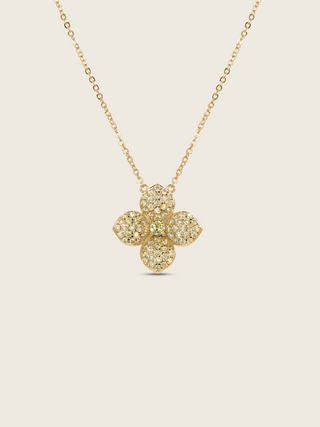 Gold plated Lemon Drop necklace with a pavé crystal four-petal flower pendant on a fine chain, shown on a neutral background.