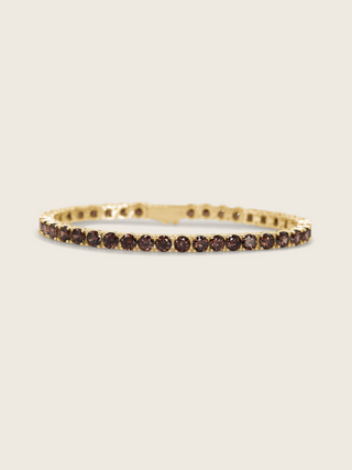 Maria Tennis Bracelet in 14k gold plating with brown cubic zirconia stones, displayed on neutral background
