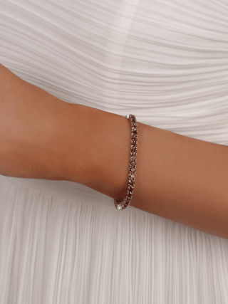 Model wearing the Maria tennis bracelet in premium white gold with wine coloured cubic zirconia stones