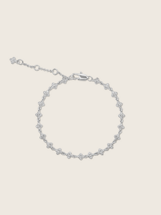 Micro hydrangea pavé bracelet in white gold displayed flatly on a white background, highlighting the sparkly, detailed design of the chain bracelet.