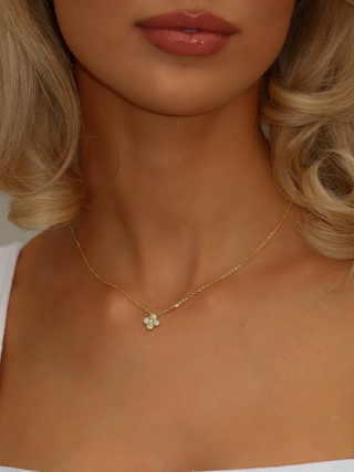 Mini Hydrangea necklace in gold plating worn by model, featuring a single pavé flower pendant on a fine gold chain