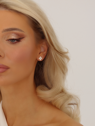 Mini Hydrangea stud earring in premium Gold plating worn on model, showcasing its pavé floral design with a soft sparkle