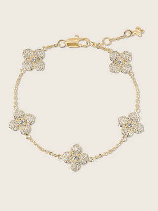 Multi Midi Hydrangea bracelet in gold plating with five pavé flower charms and adjustable clasp, shown on neutral background