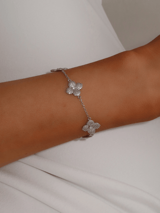 Multi Midi Hydrangea bracelet in premium White Gold plating worn on wrist, featuring delicate pavé floral motifs and fine chain