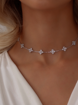 Multi Mini Hydrangea necklace in White Gold plating worn on model, featuring a delicate row of small pavé flower motifs across the neckline