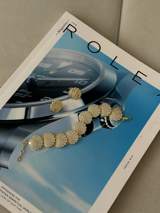 Muriel earrings in 14k gold plating shown with the Muriel pavé bracelet on magazine flatlay