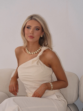 Model wearing full Muriel set including necklace, earrings, and bracelet in 14k gold plated finish