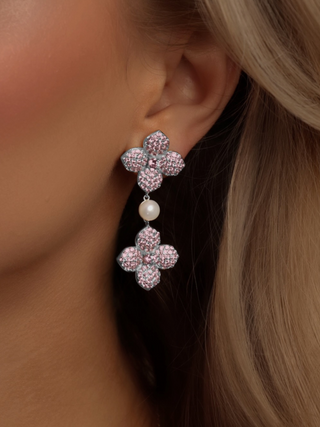 Hydrangea drop earrings in white gold with pink CZ stones and freshwater pearl detail, worn on ear for an elegant, romantic look with graceful drop length