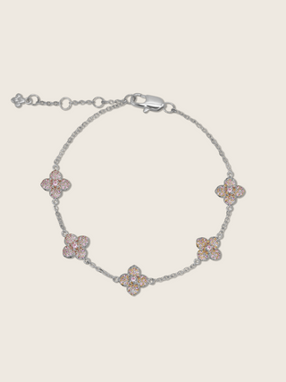 White gold plated bracelet with five light pink cubic zirconia hydrangea charms on fine chain, shown on neutral background