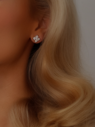 Close-up of the White Gold Plated Mini Crystal Hydrangea Stud earring on a model's ear, highlighting the intricate hydrangea design and sparkling CZ stone.
