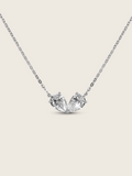 Adore necklace featuring two pear-cut cubic zirconia stones set side by side in white gold plated brass, symbolising love and unity on a fine chain, displayed on a neutral background