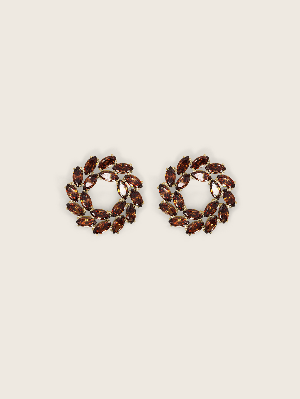 Gold plated stud earrings with brown marquise and round-cut stones in a wreath-style circular design on a neutral background