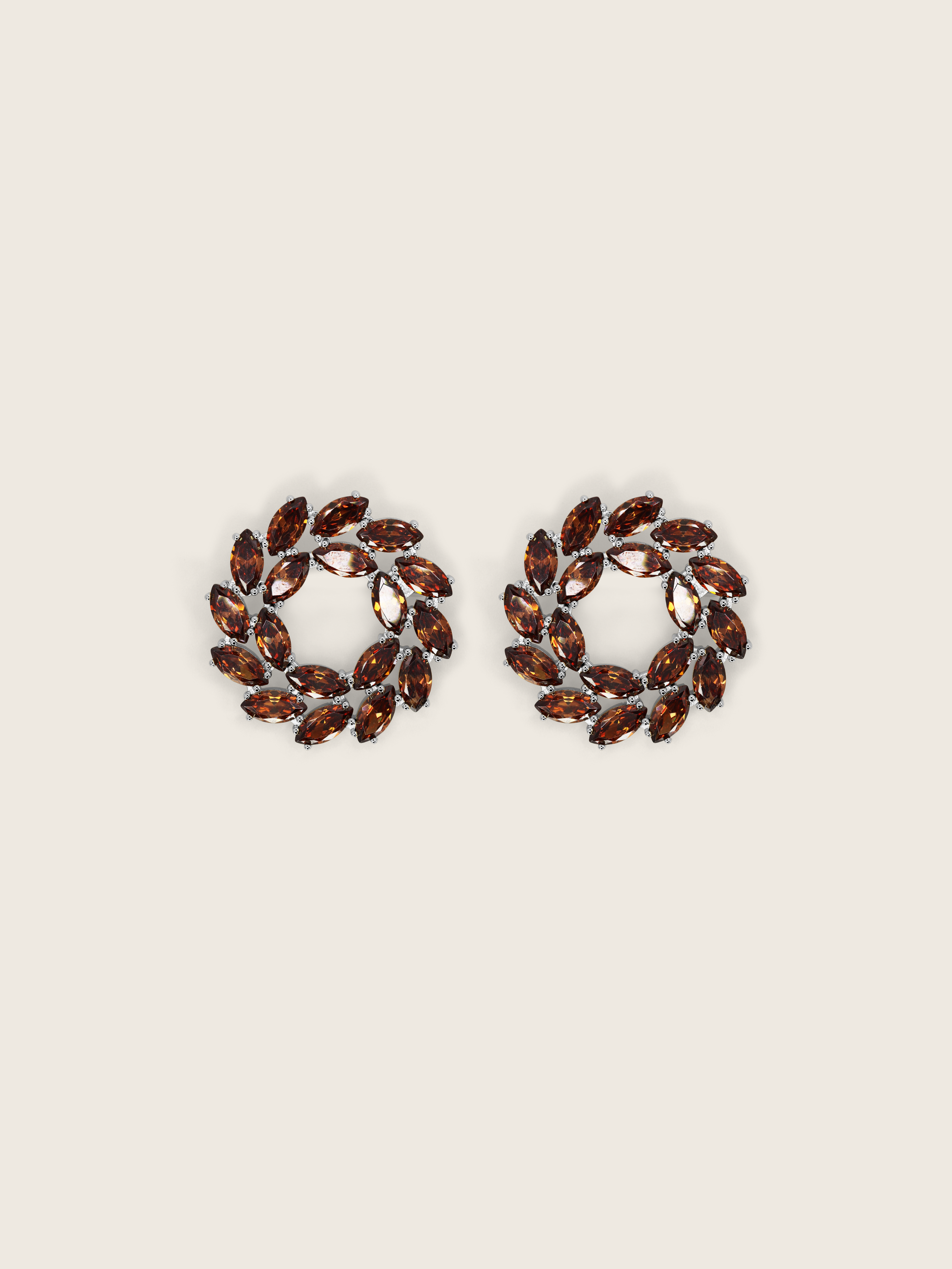 White gold wreath-style stud earrings featuring clustered brown marquise and round-cut stones in a circular silhouette on a neutral background