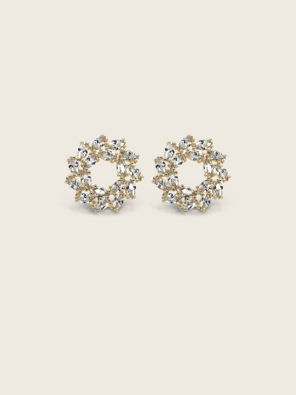 Gold plated wreath-style stud earrings with clustered marquise and round-cut clear stones on a neutral background