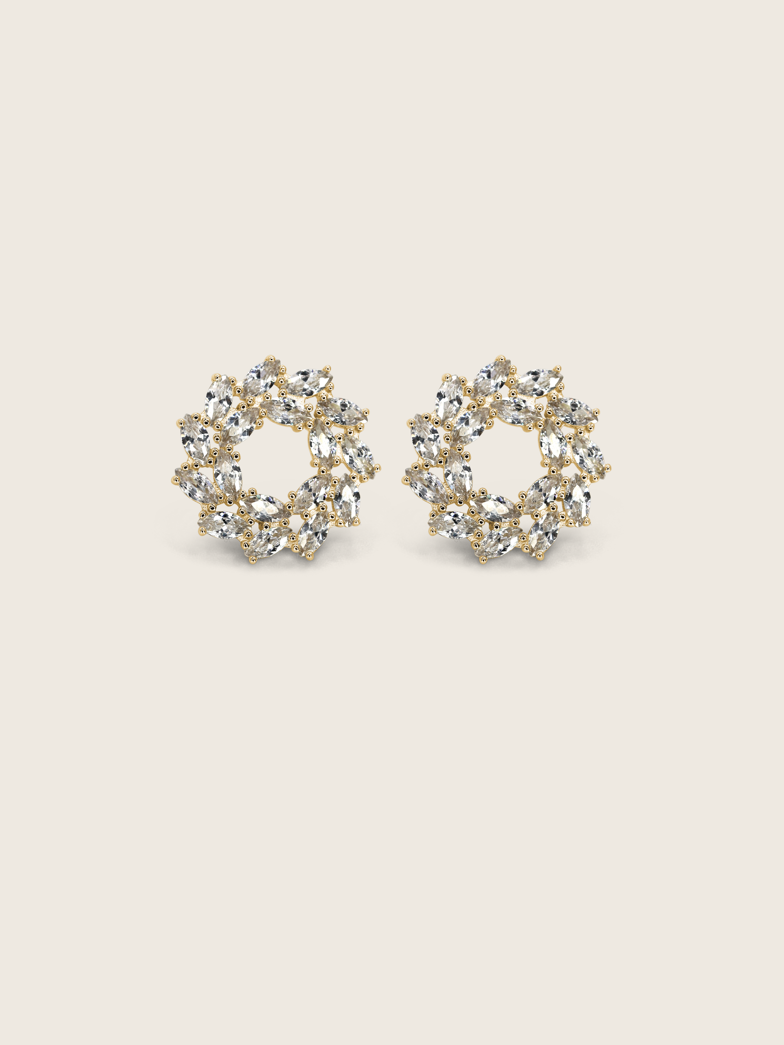 Gold plated wreath-style stud earrings with clustered marquise and round-cut clear stones on a neutral background