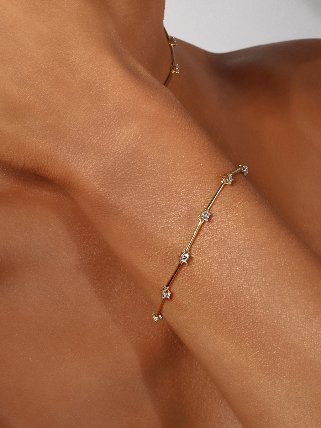 Gold plated Astra bracelet with cubic zirconia stars, styled on wrist