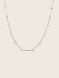 Gold plated Astra necklace with cubic zirconia star details, flat lay on white background