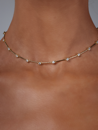 Astra necklace in gold plating with cubic zirconia stars, worn close to the neck