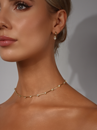Astra bar set station necklace 14k gold plated with cubic zirconia stones styled with Luna hoop earrings 14k gold plated sterling silver cubic zirconia drop on model