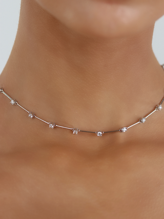 Astra necklace with premium white gold plating and cubic zirconia stars, close up on neckline
