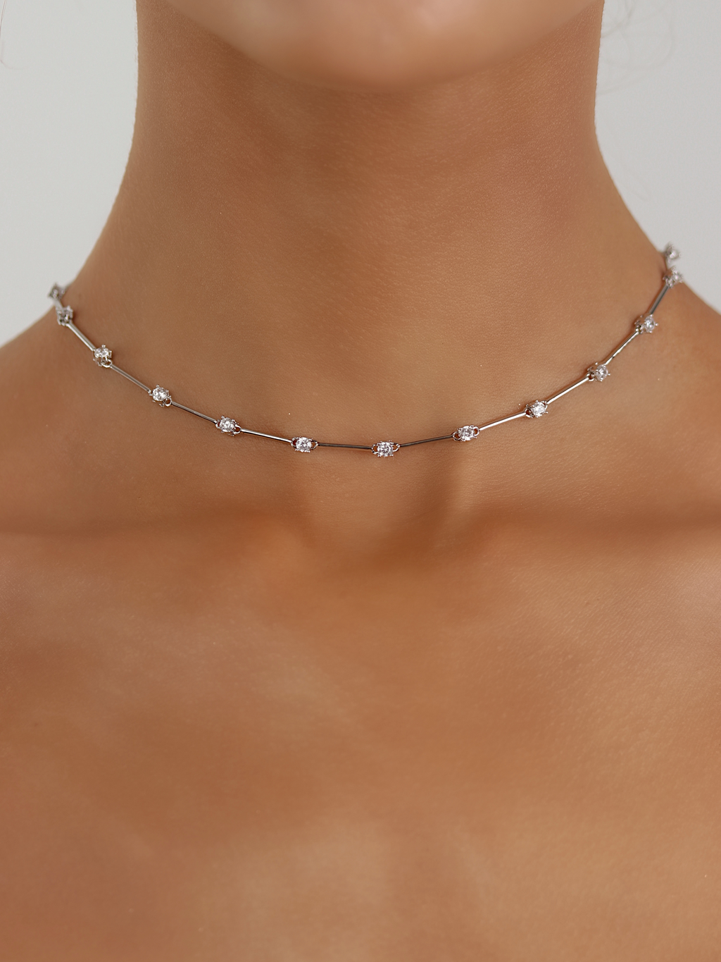 White gold plated Astra necklace with cubic zirconia star details, worn around the neck