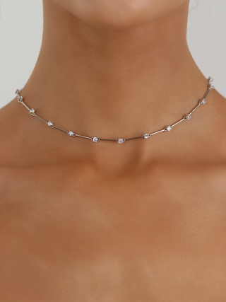 White gold plated Astra necklace with cubic zirconia star details, worn around the neck