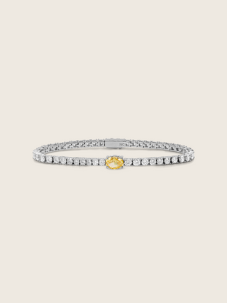 Gold tennis bracelet with central lemon yellow oval CZ stone and clear CZ detailing throughout
