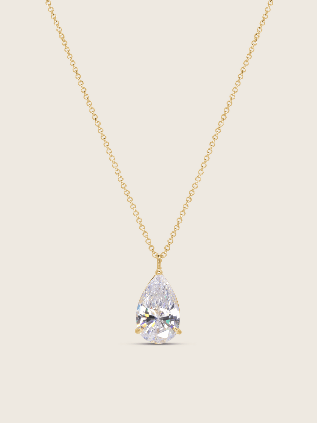 gold plated aurora necklace with a teardrop-shaped cz pendant on a neutral background