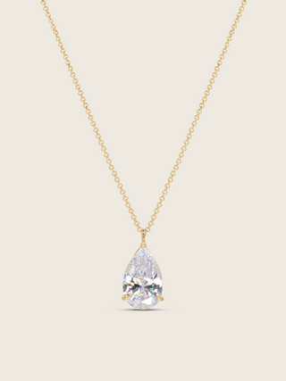 gold plated aurora necklace with a teardrop-shaped cz pendant on a neutral background