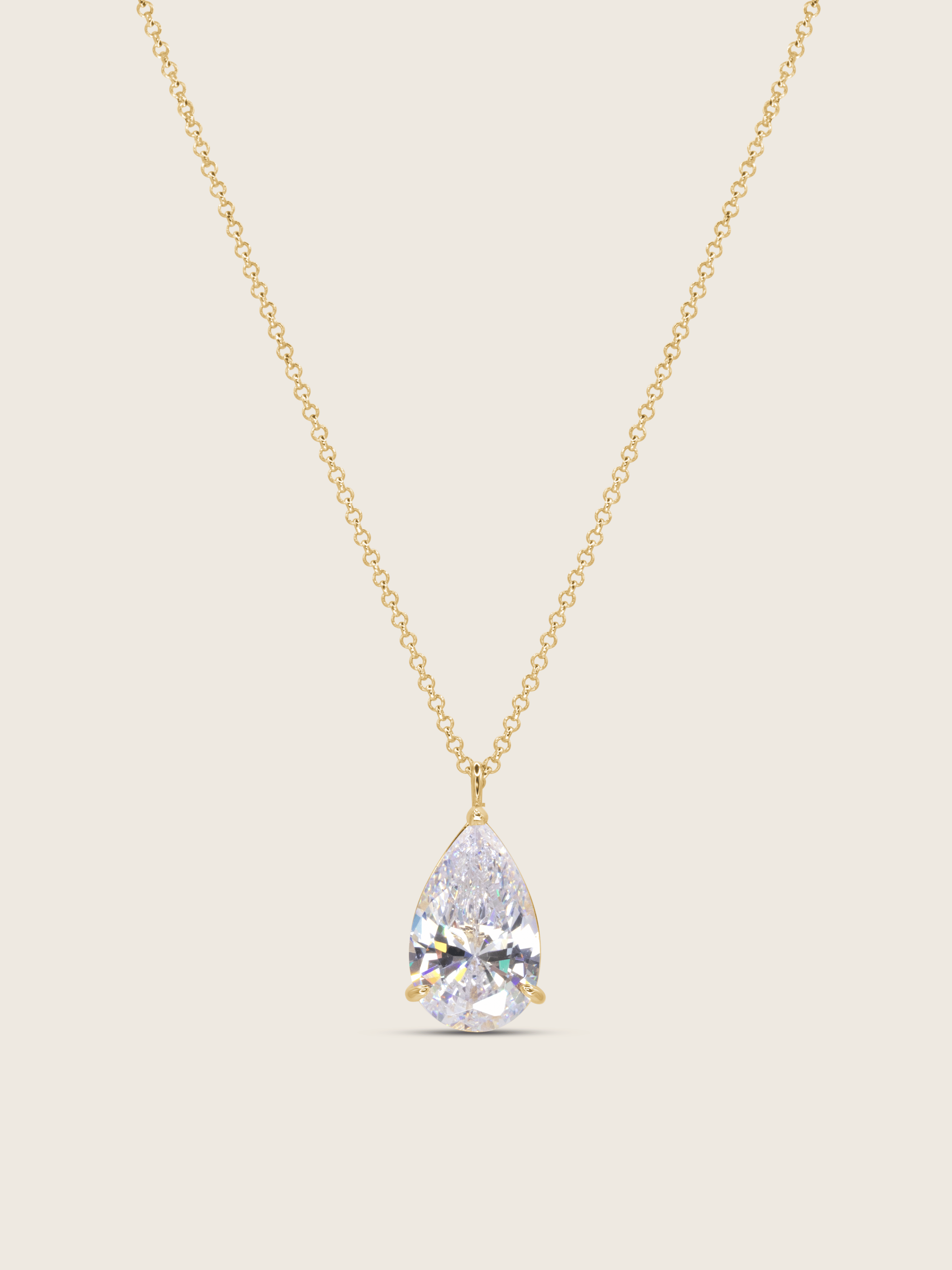 gold plated aurora necklace with a teardrop-shaped cz pendant on a neutral background
