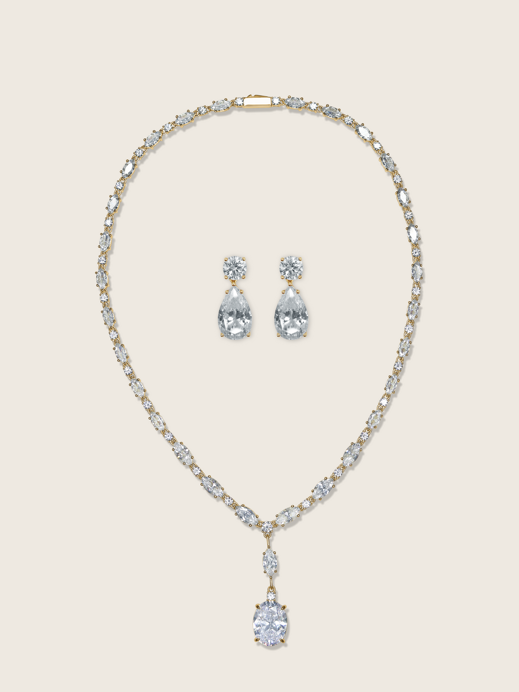 Bridget necklace and Alexandra earrings set in gold with cubic zirconia stones on neutral background