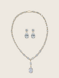 Bridget necklace and Alexandra earrings set in gold with cubic zirconia stones on neutral background