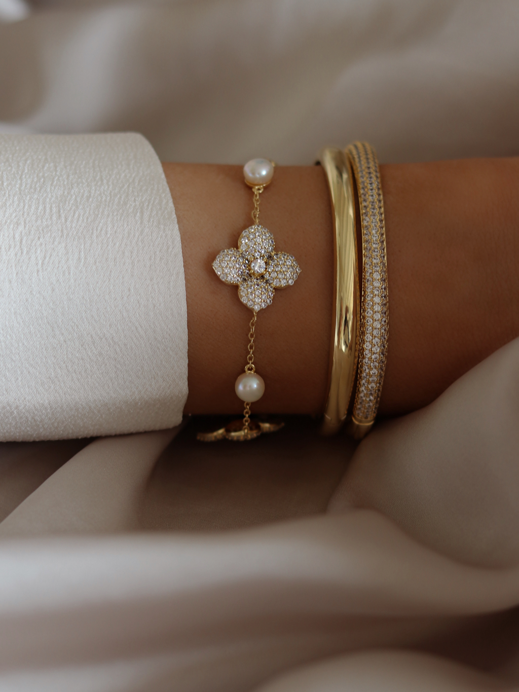 Christy bangle and pavé bangle styled with multi midi Hydrangea bracelet featuring pearls and CZ floral charm