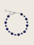 Clarissa white gold plated bracelet with round navy blue cubic zirconia stones in a graduated tennis design, elegant fine jewellery for women, shown on a white background.