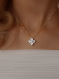 Model wearing the Crystal Hydrangea Necklace with a gold-plated chain, styled with a white dress to show the neckline and elegant floral pendant.