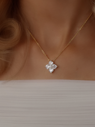 Model wearing the Crystal Hydrangea Necklace with a gold-plated chain, styled with a white dress to show the neckline and elegant floral pendant.