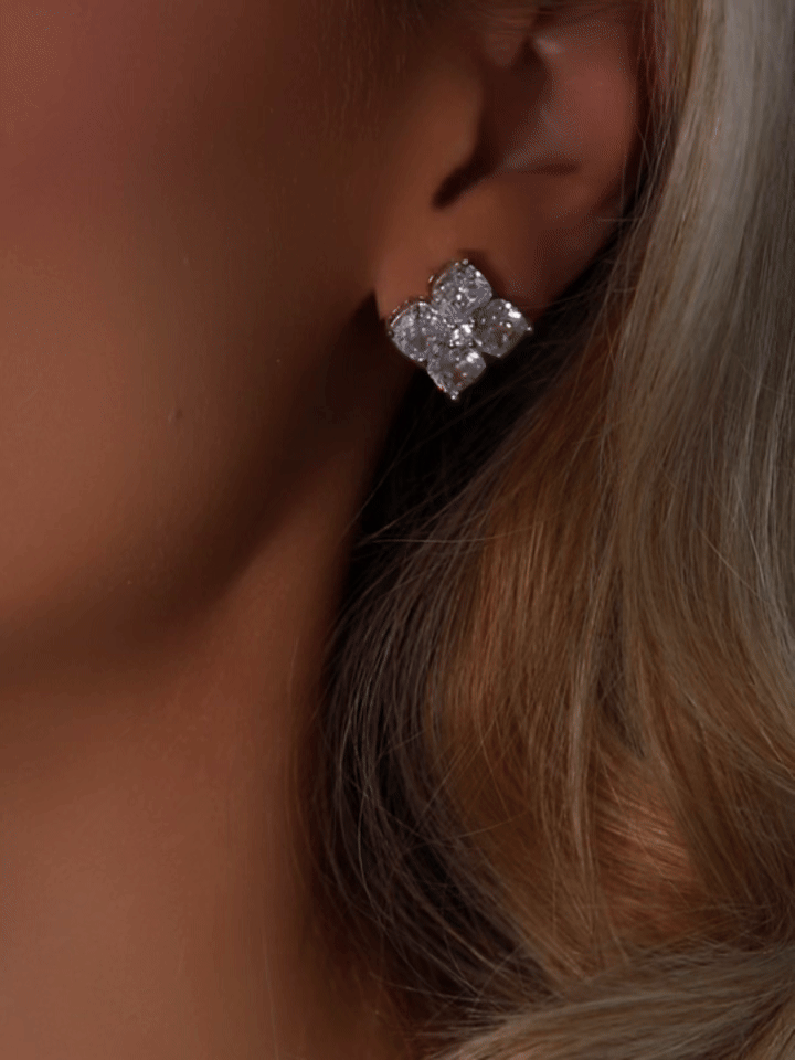 Animated close-up of a model wearing the Crystal Hydrangea Stud Earring, gently turning to reveal the sparkle and dimension of the CZ stones in a white gold plated sterling silver setting.