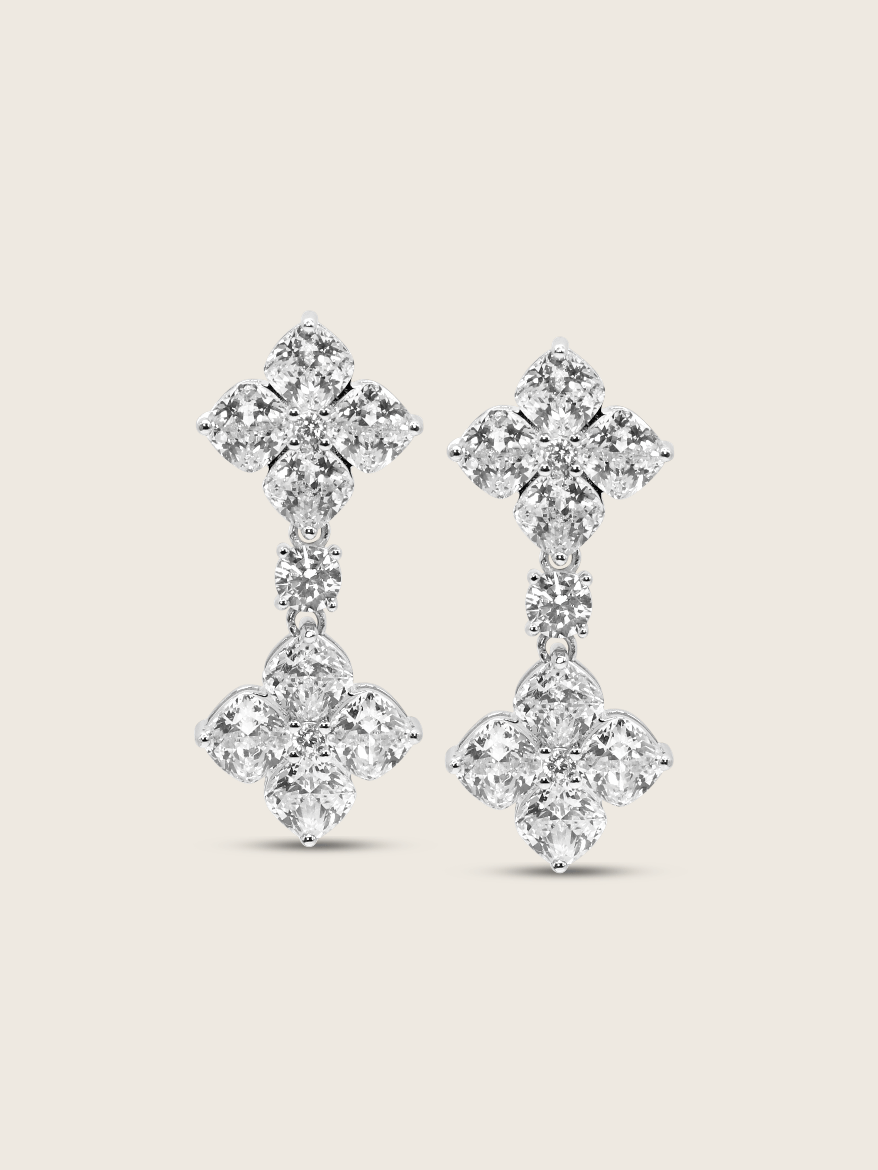 The Double Crystal Drop Hydrangea Earrings featuring two sparkling CZ stones linked by a delicate connecting stone, set in sterling silver with white gold plating, displayed on a clean white background.
