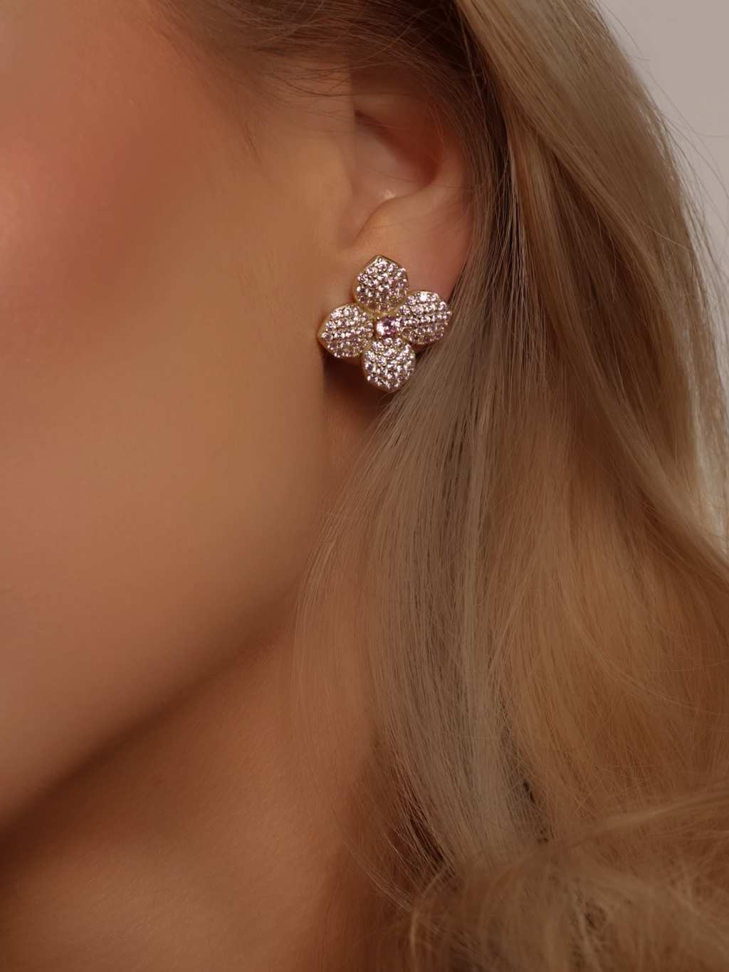 Light pink CZ hydrangea stud earring in gold, worn close to the ear for a statement floral touch - elegant and radiant for day-to-night wear