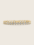 Gold plated heart tennis bracelet with bezel-set heart-cut cubic zirconia stones, elegant and romantic with a warm-toned finish, photographed on a neutral background