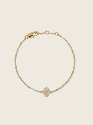 Flatlay of gold plated Mini Hydrangea bracelet with single flower charm and lobster clasp