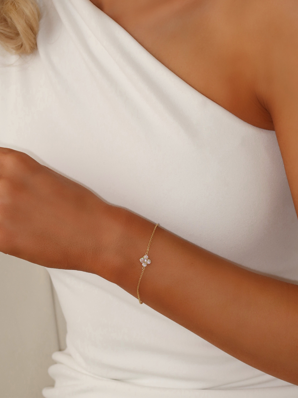  Gold plated Mini Hydrangea bracelet shown on wrist, styled with white one shoulder dress