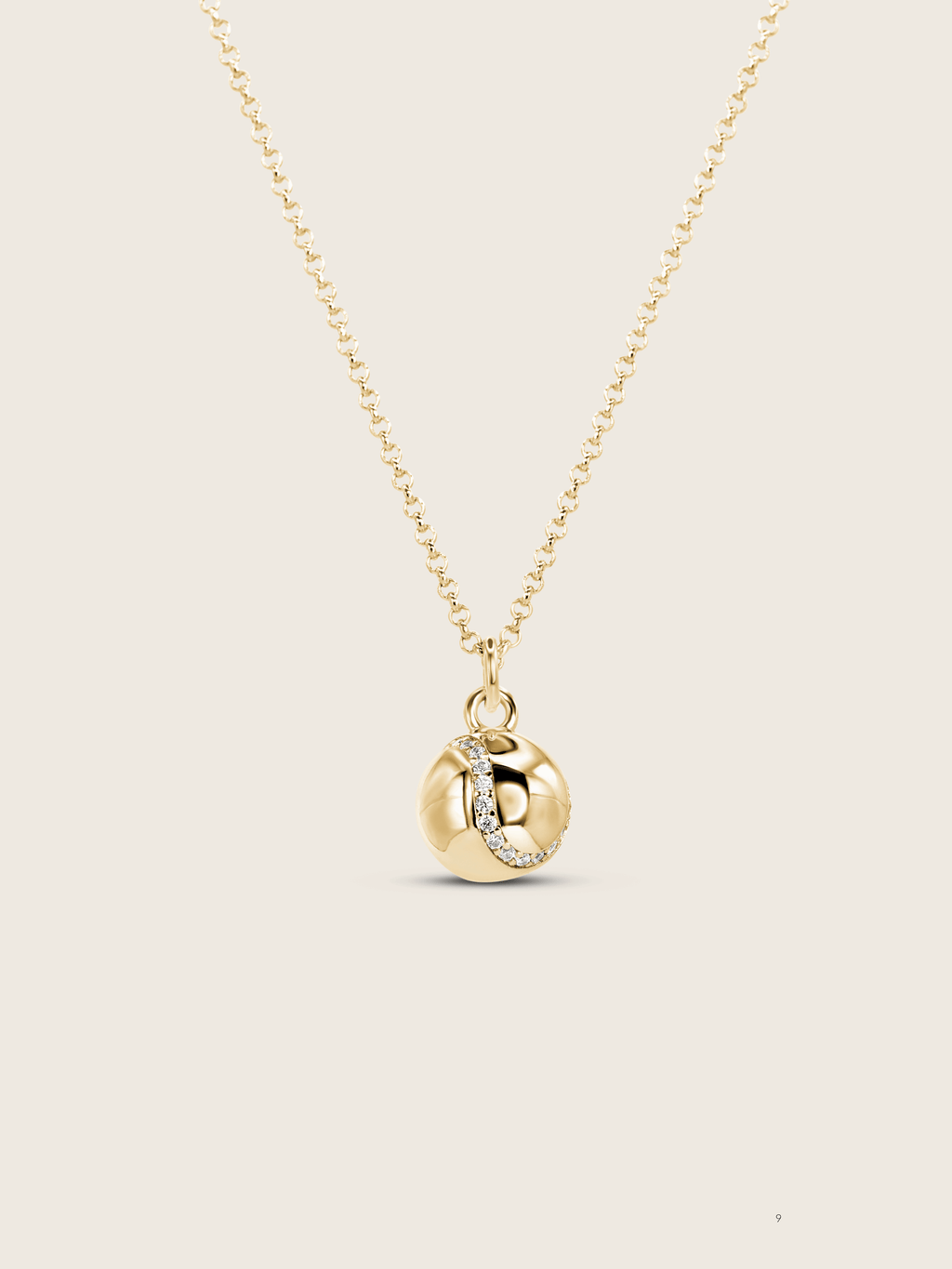 Gold plated tennis ball pendant necklace with semi pavé CZ stones on a fine chain